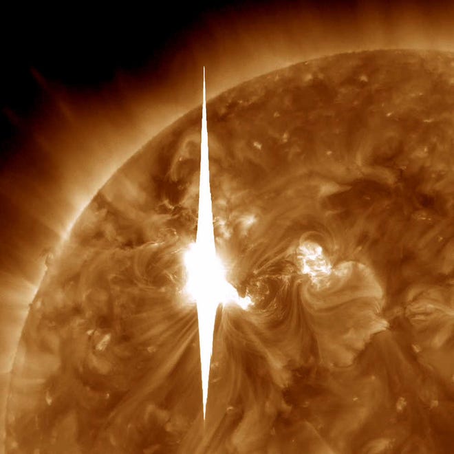 An impressive solar flare is shown heading toward Earth. It could disrupt power grids, GPS and airplane flights. Forecasters at the National Oceanic and Atmospheric Administration's (NOAA) Space Weather Prediction Center said the sun erupted Tuesday evening and the effects should start smacking Earth late Wednesday night, close to midnight EST. They say it is the biggest in five years and growing. (AP Photo/NASA)