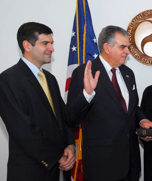 In this Jan. 23, 2009 handout file photo proved by the Transportation Department, Sam Lahood, left, watches as his father Ray is sworn in as Transportation Secretary, at the Transportation Department in Washington. Three U.S. citizens whom Egyptian authorities have barred from leaving the country have sought refuge in the American Embassy in Cairo, U.S. officials said Monday, Jan. 30, 2012. Those banned include Sam LaHood, son of U.S. Transportation Secretary Ray LaHood, but officials would not say whether he is at the embassy. (AP Photo/ Transportation Department, File)