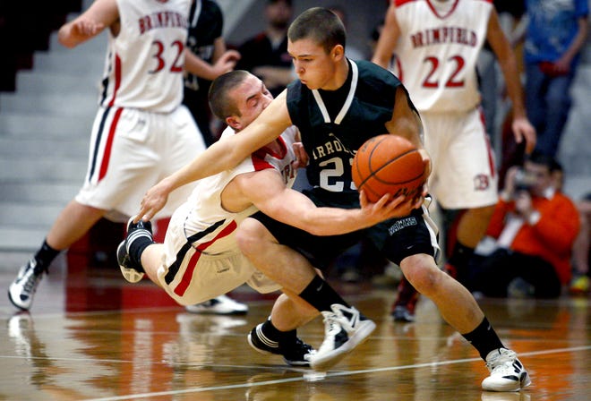 Brimfield's Danny Dwyer knocks the ball loose from Carrollton's Luke Palan on Tuesday during the Class 1A Jacksonville Supersectional.