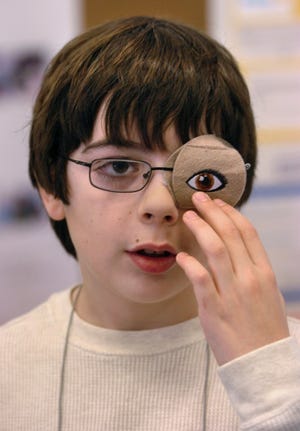 Rush Intermediate School (Cinnaminson, NJ) fifth grader Nicholas Hite wears an eye patch to show his invention to the judges. His invention titled "Amblyopia Adventures" shows how a sufferer of Amblyopia would wear an eyepatch over the good eye so the weak eye can be strengthened and enjoyed with the use of different designs on the eyepatches.