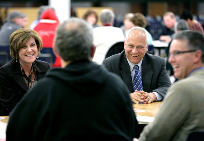Massillon City Schools Curriculum Director Lori DaVila and Superintendent Rik Goodright share a laugh with district residents during a round-table discussion regarding the future of Massillon schools.