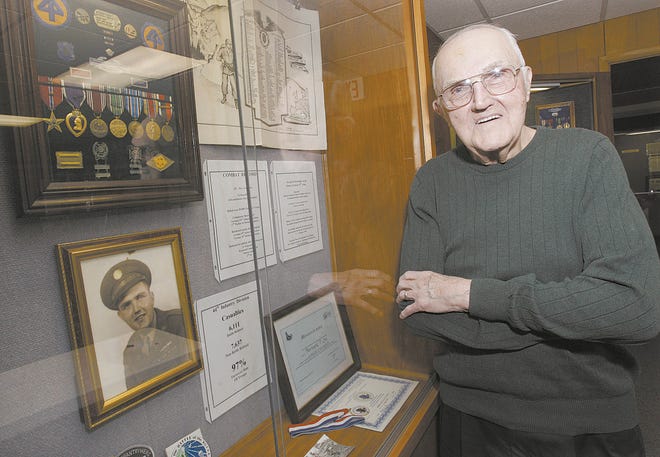 Bernard P. Ott of Massillon with a memorabilia display at the Ohio Military Museum from his time in the service.
