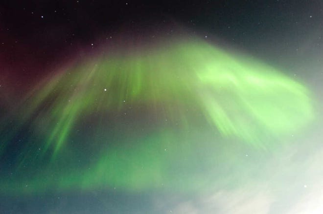 The northern lights or aurora borealis fill the sky above Soldotna, Alaska, early Wednesday. For North America, the good part of a solar storm - the one that creates more noticeable auroras - was expected to peak Thursday evening.