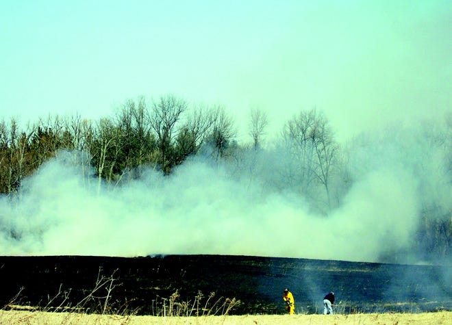 Hopewell firefighters work to contain a brush fire off Stoddard Road.
