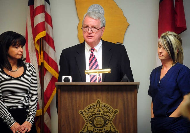 Sheriff Ronnie Strength stands with his wife, Patti, and stepdaughter Heather as he announces he will not seek re-election.