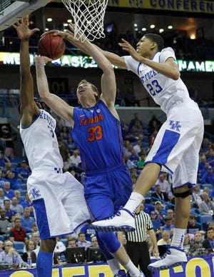Kentucky's Anthony Davis (right) blocks a shot by Florida's Erik Murphy during the SEC Tournament semifinals. Davis had 15 points and 12 boards in the Wildcats' victory.