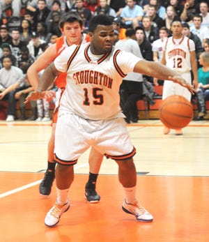 Stoughton's Raymond Bowdre rebounds in front of Oliver Ames forward Jeff Babbitt. Hundreds of fans were turned away at Stoughton High School for the Black Knights' 61-44 victory in a clash of two teams that were unbeaten going into Friday night's clash.