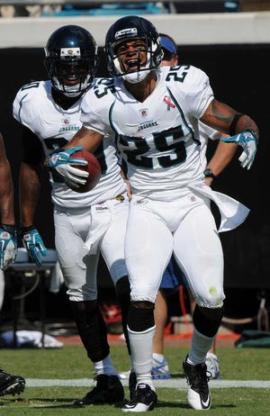 Bob.Mack@jacksonville.com The Jaguars' Dwight Lowery (25) celebrates with Drew Coleman after intercepting a pass against the Titans on Sept. 11.