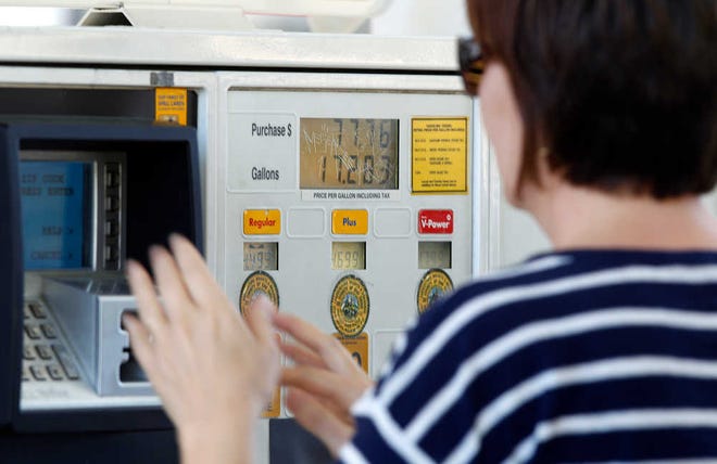 A gas customer views the price of a sale on the pump at a Shell Oil gas station on Feb. 21 in Del Mar, Calif. Taking some simple steps can help consumers save money on gasoline.