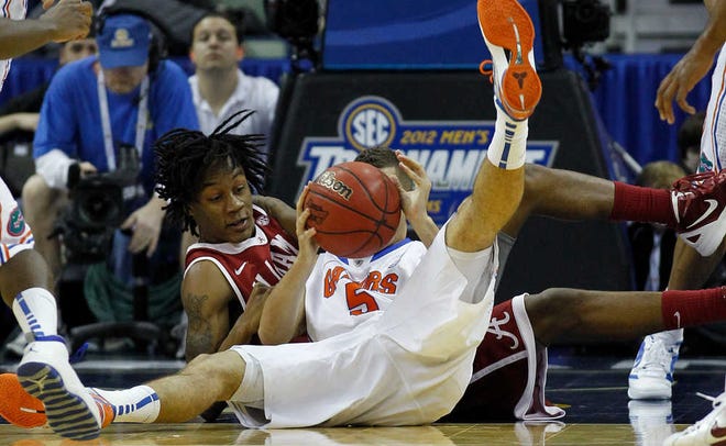 Alabama guard Levi Randolph (20) fights for the ball with Florida guard Scottie Wilbekin Friday during the first half a Southeastern Conference tournament second-round game.