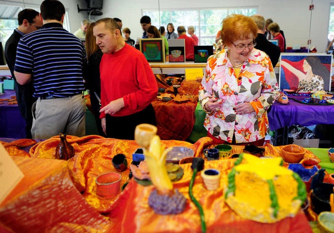 People peruse the many handmade bowls available at the Empty Bowl fundraiser for the Golden Harvest Food Bank and the Augusta Jewish Community Center.