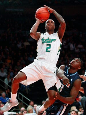 South Florida's Victor Rudd Jr. (2) shoots over Villanova's Mouphtaou Yarou (13) in the first half of a second-round of the Big East tournament in New York.