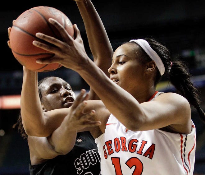 Georgia forward Jasmine Hassell (12) protects the ball from South Carolina forward Aleighsa Welch, left, in the first half of an NCAA college basketball game at the women's Southeastern Conference tournament on Friday, March 2, 2012, in Nashville, Tenn. (AP Photo/Mark Humphrey)