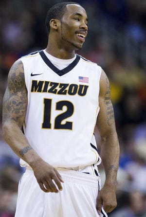Missouri Tigers guard Marcus Denmon (12) smiled after making a basket against Oklahoma State in the closing minute of the first half of the Big 12 Men's Basketball Tournament at the Sprint Center on Thursday, March 8, 2012, in Kansas City, Missouri. (Shane Keyser/Kansas City Star/MCT)