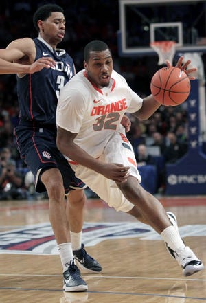 Syracuse's Kris Joseph, right, pushes past Connecticut's Jeremy Lamb during the quarterfinal round of the Big East NCAA college basketball conference tournament in New York, Thursday, March 8, 2012. (AP Photo/Seth Wenig)