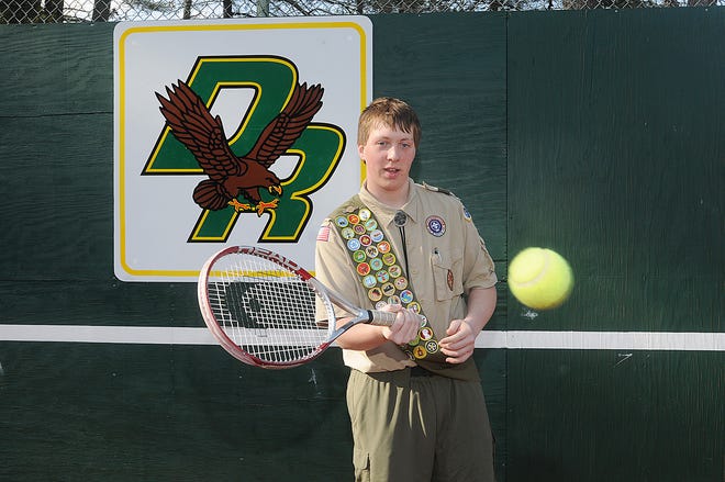Boy Scout Stephen Munroe hits a few tennis balls in front of the new backboard he installed as part of his Eagle Scout project.