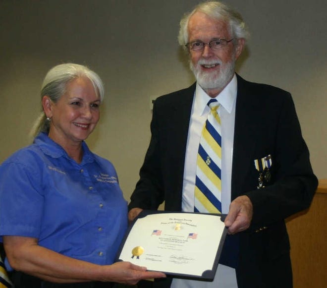 Shelia Bell accepts her certificate from Bill McPherson. The presentation was made during a meeting of the St. Augutine Beach City Commission. Contributed photo.