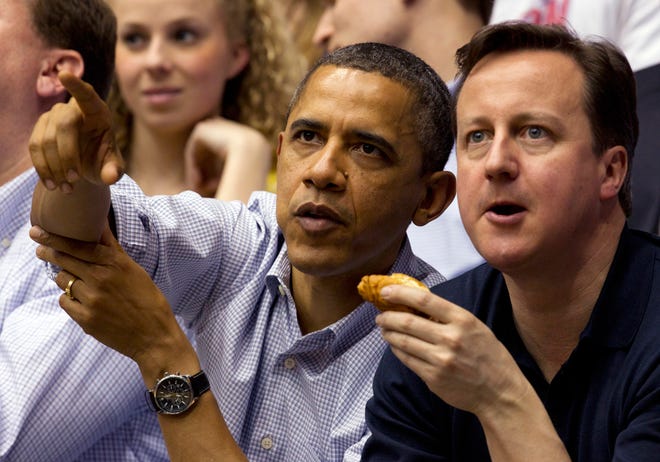 President Barack Obama and Britain Prime Minister David Cameron attend the Mississippi Valley State game against Western Kentucky in a first round NCAA tournament basketball game, Tuesday, March 13, 2012, at University of Dayton Arena, in Dayton, Ohio. (AP Photo/Carolyn Kaster)