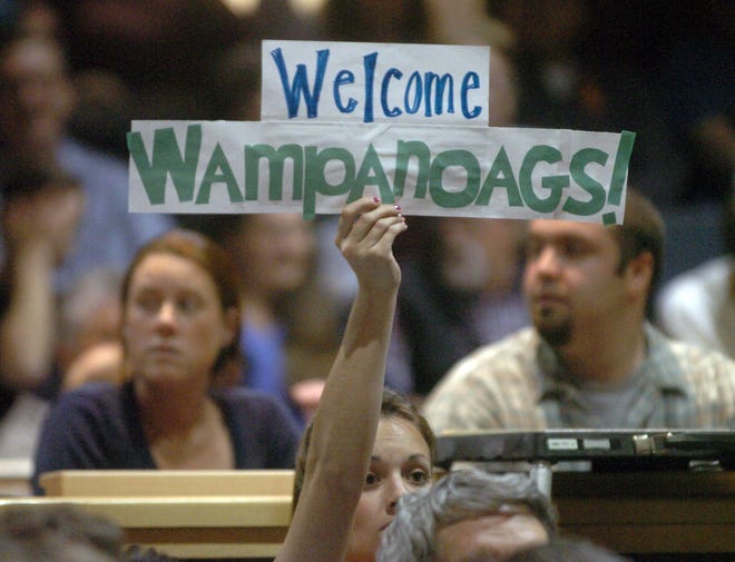 Leah Kutzy of Middleboro holds a sign welcoming the tribe to the town at a town meeting in 2007. The town and the tribe have had less-than-cordial relations of late.