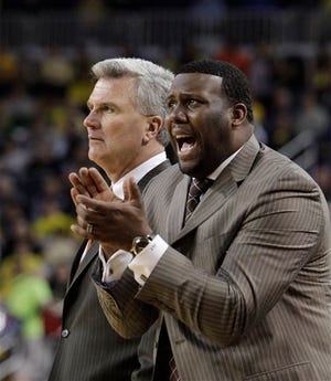 Illinois head coach Bruce Weber, left, and assistant coach Jerrance Howard watch from the sidlines during the second half of an NCAA college basketball game against Michigan at Crisler Center in Ann Arbor, Mich., Sunday, Feb. 12, 2012. (AP Photo/Carlos Osorio)