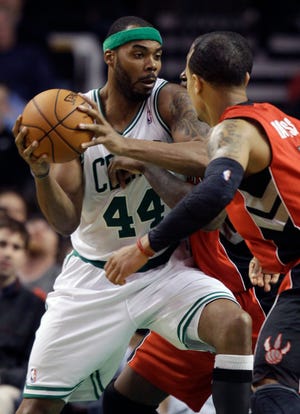 Boston Celtics forward Chris Wilcox (44) drives to the basket against Toronto Raptors guard Jerryd Bayless (5) during the second half of their NBA basketball game in Boston, Wednesday, Feb. 1, 2012. The Celtics defeated the Raptors 100-64.