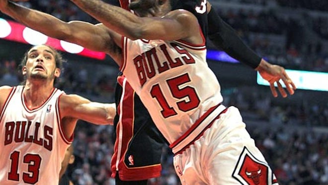 The Chicago Bulls' John Lucas III (15) drives on the Miami Heat's Dwyane Wade during the second quarter of the Heat's loss on Wednesday, March 14, 2012, in Chicago.