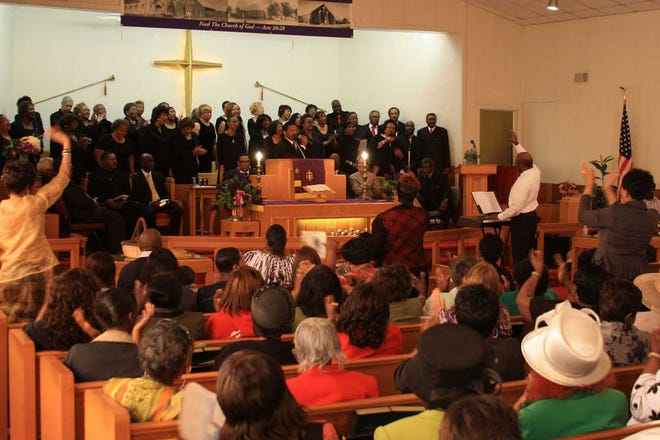 Clergy, choir and congregation at Carter Chapel Christian Methodist Episcopal Church, 412 S.W. Second Ave., participate in the 2011 "100 Men in Black" worship service.