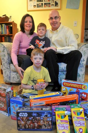 Connor Daley, foreground, is holding a toy drive for Children’s Hospital in Boston. With him are his parents, Janet and Ken, and his brother, Jack.