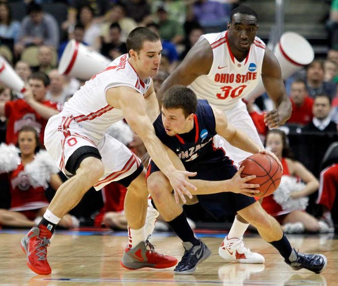 Ohio State's Aaron Craft (left) and Evan Ravenel (right) pressure Gonzaga's Kevin Pangos during the first half. The Buckeyes advanced to the Sweet 16 with the win.