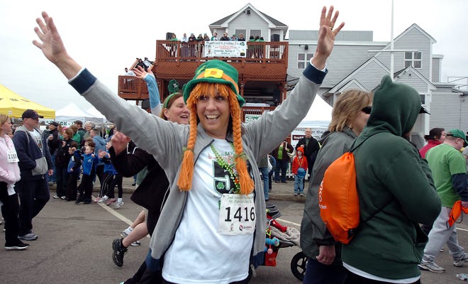 Patti Mederios waves to a friend as she starts the second annual St. Patrick's Day 5-K road race in Marshfield, Saturday, March 17, 2012.

photo: Amelia Kunhardt/The Patriot Ledger