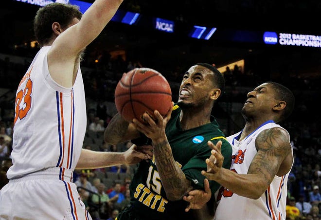Norfolk State guard Rodney McCauley (15) struggles between Florida defenders Bradley Beal and Erik Murphy (33) during the first half of a third round NCAA college basketball tournament game at CenturyLink Center in Omaha, Neb., Sunday, March 18, 2012. (AP Photo/Nati Harnik)