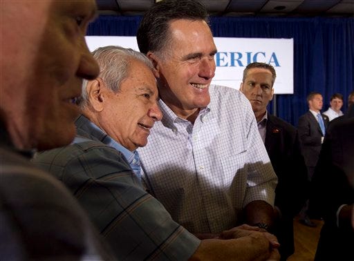Republican presidential candidate, former Massachusetts Gov. Mitt Romney, center right, greets people during a campaign stop Sunday, March 18, 2012, in Moline, Ill. (AP Photo/Steven Senne)