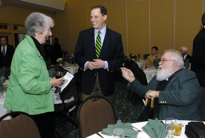 NORWICH 3-17-2012 JOHN SHISHMANIAN  Mary Miskiewicz, left, Rep. Tom Reynolds and Rev. David Cannon are wearing green Saturday at the Socitey of Friendly Sons of St. Patrick dinner at th Norwich Holiday Inn.  John Shishmanian/ NorwichBulletin.com