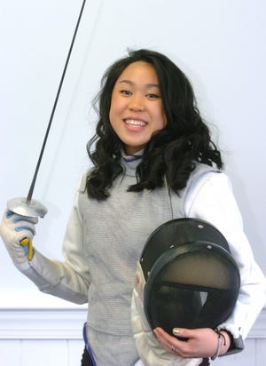 Rancocas Valley Regional High School sophomore and fencer Rachel Yee stands with her epee and her mask. She was recognized at a recent school board meeting and will represent the state of New Jersey at a national conference of school board members.
