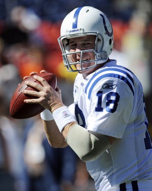 In this Sept. 26, 2010 file photo, Indianapolis Colts quarterback Peyton Manning passes prior to and NFL football game between the Indianapolis Colts and the Denver Broncos, in Denver. (AP Photo/Jack Dempsey, File)
