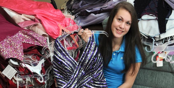 Nia Rametta, 17, of Reeders, a senior at Pocono Mountain East, shows off one of the hundreds of prom dresses that she's collected as part of Becca's Closet. The program helps high school girls who might not be able to afford a stylish gown for the prom by giving them dozens to choose from, along with shoes and accessories. This is the last year that Rametta will be in charge of the program, as she heads off to college, and hopes that another girl will come forward to carry the sequined torch.