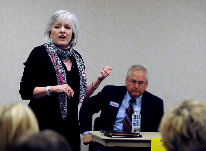 State Board of Education candidate Anette Carlisle, president of Amarillo Independent School District board of trustees, introduces herself while Amarillo attorney Marty Rowley listen Tuesday during the candidate forum at the Amarillo Public Library Southwest Branch. The forum was hosted by the Amarillo Tea Party Patriots.