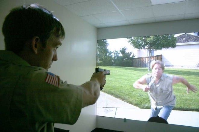 SJR State recently introduced its new simulation training lab to students enrolled in the criminal justice program. Cadet Brian Stanley, left, responds to a "suspect" during a training exercise. The videos are based on realistic situations with multiple suspects and outcomes from which to select. Contributed photo