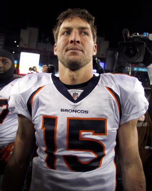 Denver Broncos quarterback Tim Tebow walks off the field following the loss against the New England Patriots Saturday night., Jan. 14, 2012, in Foxborough, Mass. The Patriots defeated the Broncos 45-10. (AP Photo/Charles Krupa)