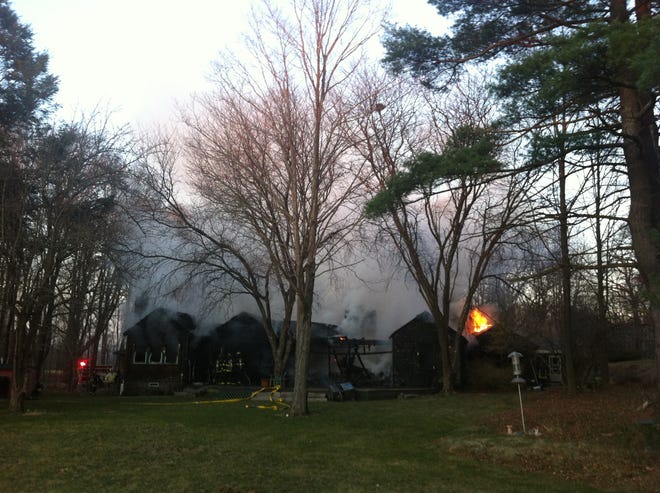 Firefighters are at the scene of a fire at 1456 Canton Ave. in Milton. Photo by Alex Jones/For The Patriot Ledger