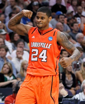 Louisville's Chane Behanan celebrates after the Cardinals knocked off top-seeded Michigan State, 57-44, on Thursday in a West Regional semifinal in Phoenix. Behanan scored 15 points.