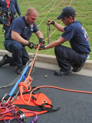 Martinez-Columbia Fire Rescue firefighters Rob Stevens and Calvin Mathes work on a rope system during training Thursday, March 22, 2012, behind Mullins Crossing shopping center in Evans. The ropes training is to prepare firefighters for steep, high-angle rescues.
