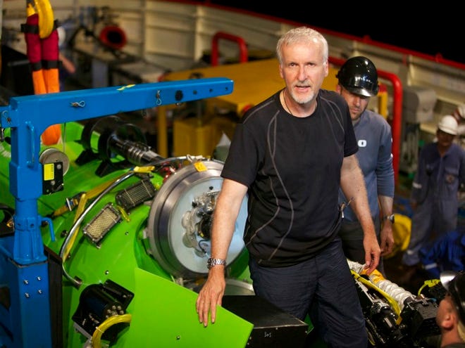 This February photo, provided by National Geographic, shows explorer and filmmaker James Cameron emerging from the hatch of DEEPSEA CHALLENGER during testing of the submersible in Jervis Bay, south of Sydney, Australia. (AP Photo / Mark Thiessen, National Geographic)