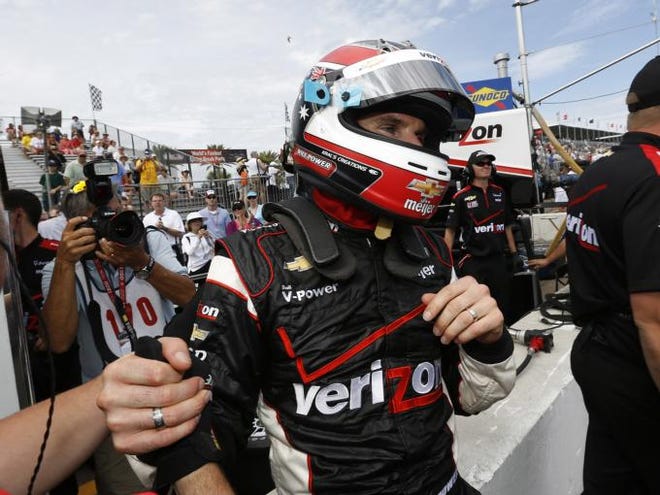 Will Power celebrates after winning the pole for Sunday's Honda Grand Prix in St. Petersburg, Fla., on Saturday, March 24, 2012.