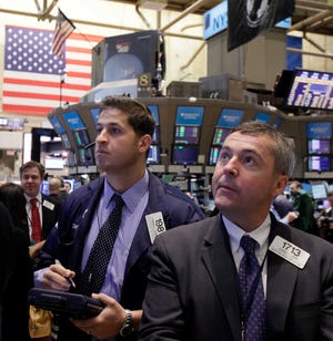 Traders work on the floor of the New York Stock Exchange. On Monday, stocks recorded one of their biggest gains of the year.