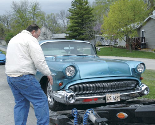 Ken Ehresman, who is spearheading his family’s trip from Los Angeles to Pontiac on Route 66, makes sure the wheels of the 1957 Buick are lined up.