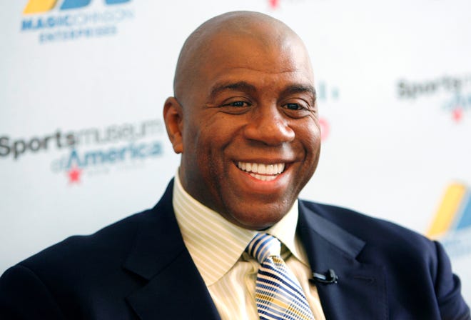 Basketball legend turned entrepreneur Magic Johnson tours the Sports Museum of America in New York, Friday, Nov. 21, 2008. A group that includes former Lakers star Magic Johnson and longtime baseball executive Stan Kasten agreed Tuesday night March 27, 2012 to buy the Los Angeles Dodgers from Frank McCourt for $2 billion.