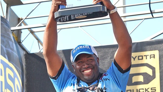 California bass pro Ish Monroe holds the victory trophy Sunday after winning $102,000 in the Bassmaster Elite Series tournament on Lake Okeechobee with a four-day weight of 108 pounds, 5 ounces.