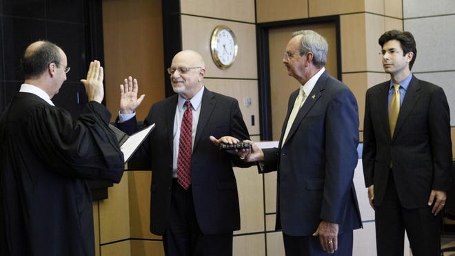 Chief Judge Peter D. Blanc swears in former statewide prosecutor Pete Antonacci as Palm Beach County's interim state attorney as Sheriff Ric Bradshaw and former state attorney Michael McAuliffe look on.