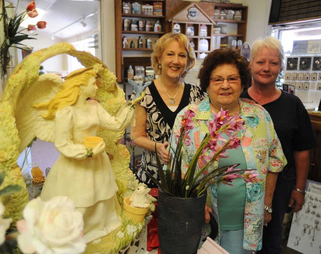 Rachel Robertson (center), the owner of Strictly Country, stands with two longtime employees Shirley Ligon (left) and Barbara Peacock. Robertson says the shop will close Saturday.